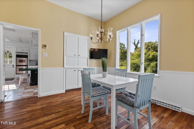 tiled dining room with a wealth of natural light and an inviting chandelier