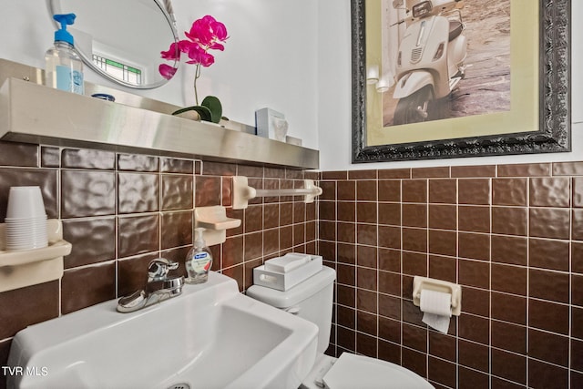 bathroom featuring sink, tasteful backsplash, toilet, and tile walls