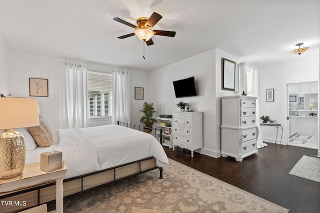 bedroom featuring dark hardwood / wood-style floors, ensuite bathroom, and ceiling fan