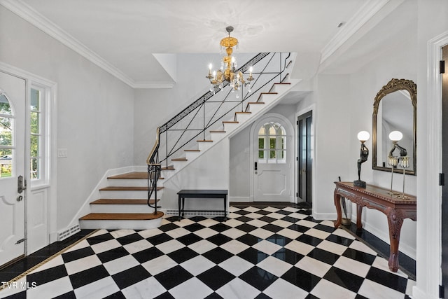 entrance foyer featuring an inviting chandelier, plenty of natural light, and dark tile floors