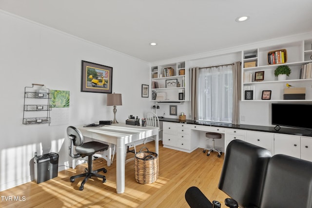 office area with light wood-type flooring and crown molding