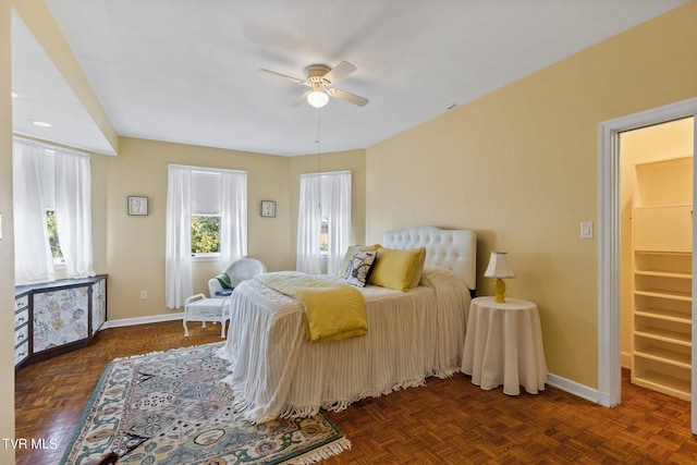 bedroom with dark parquet floors and ceiling fan