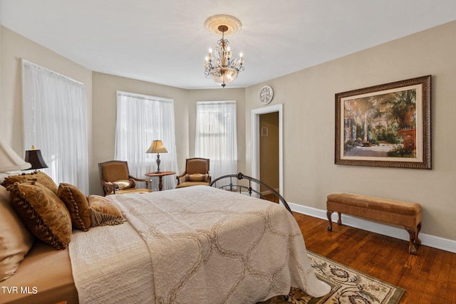 bedroom featuring a notable chandelier and dark hardwood / wood-style floors