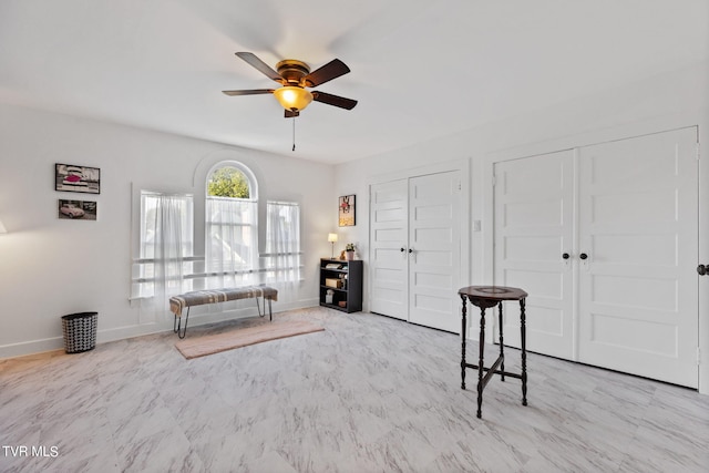 sitting room featuring ceiling fan and light tile flooring