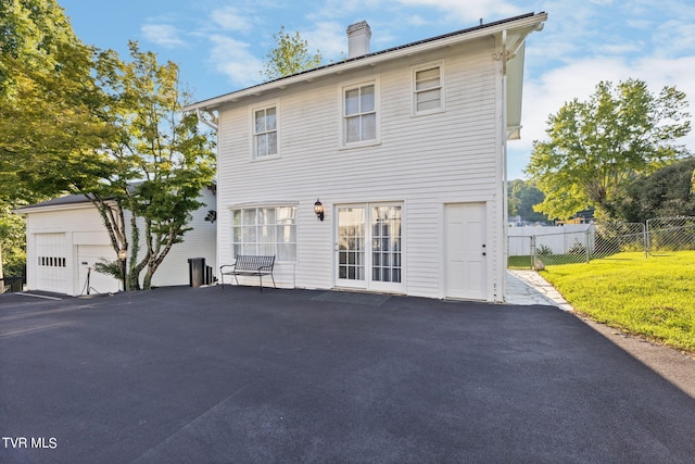 view of front of property with a front lawn and a garage