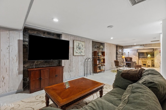 carpeted living room with wooden walls