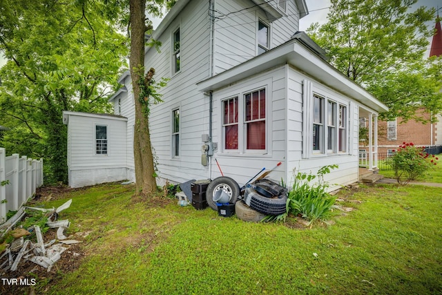 view of property exterior featuring a yard and fence