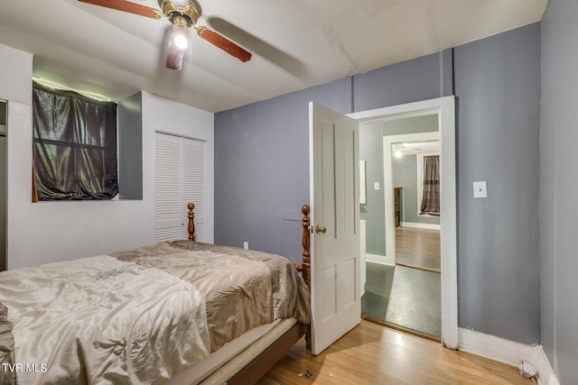 bedroom featuring a closet, a ceiling fan, and wood finished floors