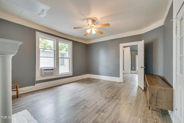 empty room featuring baseboards, a ceiling fan, and wood finished floors