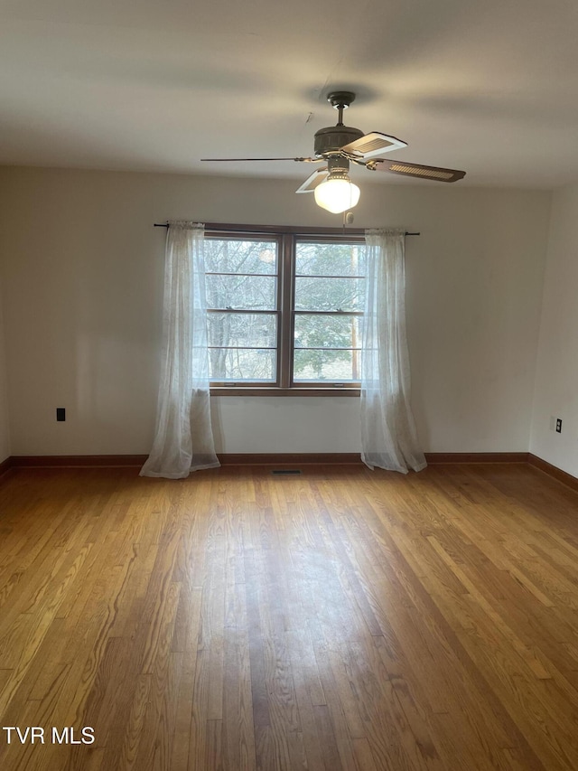 unfurnished room featuring ceiling fan and light wood-type flooring