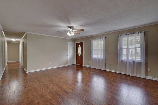 interior space with crown molding, dark wood-type flooring, ceiling fan, and a textured ceiling