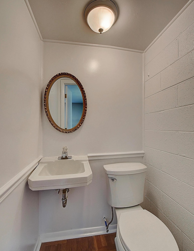 bathroom featuring sink, wood-type flooring, and toilet