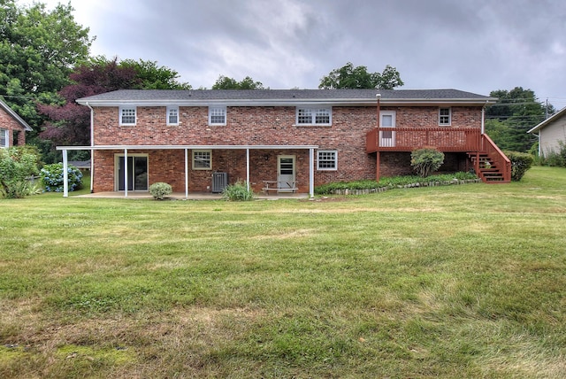 back of property featuring a wooden deck, central AC unit, a lawn, and a patio area