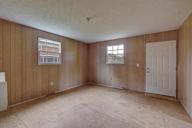 unfurnished room with a textured ceiling