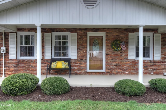 view of exterior entry with covered porch