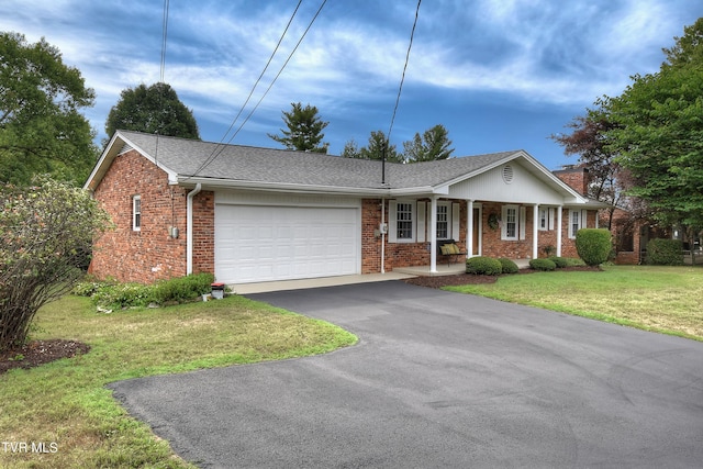 ranch-style home featuring a garage and a front lawn