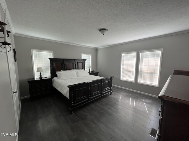 bedroom featuring ornamental molding, dark hardwood / wood-style floors, and a textured ceiling