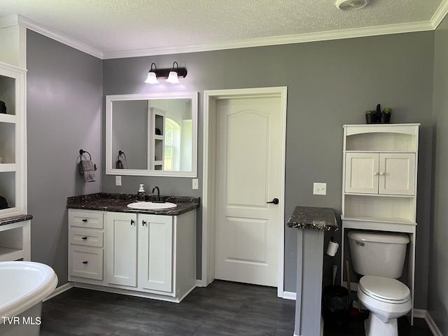 bathroom with ornamental molding, a textured ceiling, toilet, and vanity