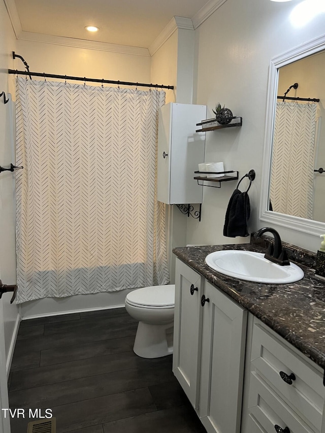 bathroom featuring ornamental molding, vanity, toilet, and hardwood / wood-style floors