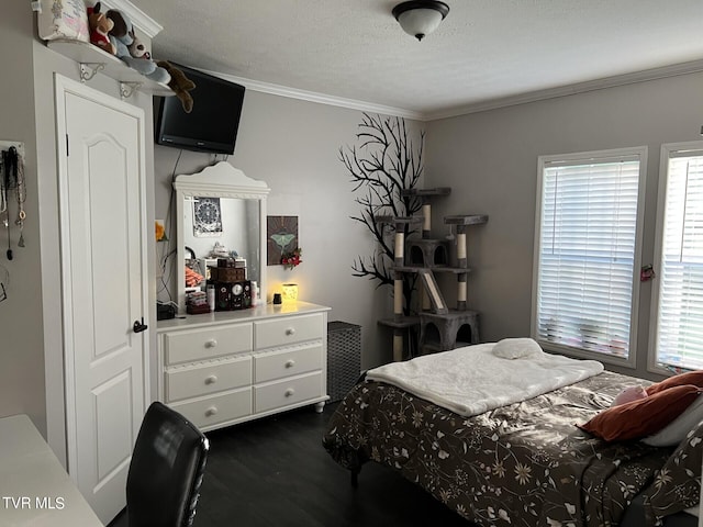 bedroom featuring a textured ceiling, dark hardwood / wood-style flooring, and crown molding