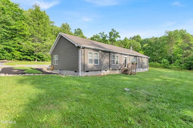 view of front of house with a front yard and a wooden deck