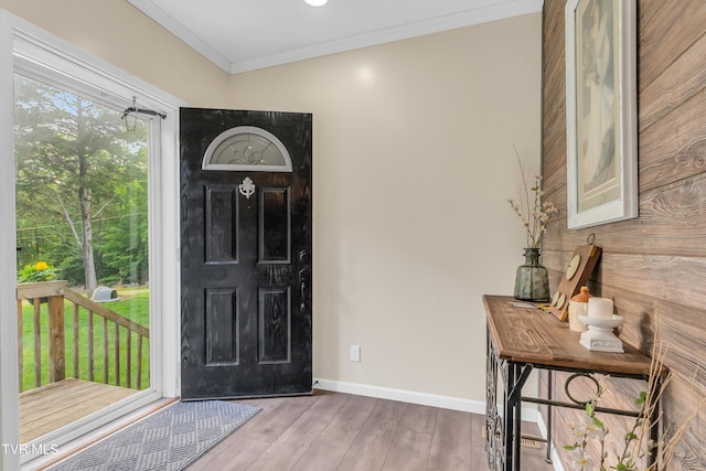 foyer entrance with a healthy amount of sunlight, hardwood / wood-style floors, and ornamental molding