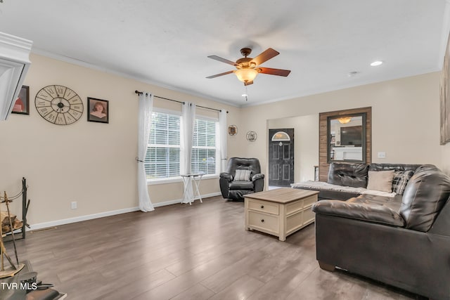 living room with ceiling fan, hardwood / wood-style floors, and ornamental molding