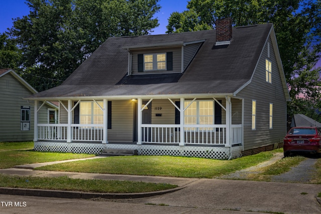 view of front of home featuring a front lawn and a porch