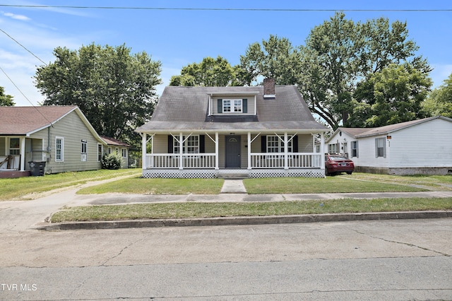 bungalow featuring a front yard and covered porch