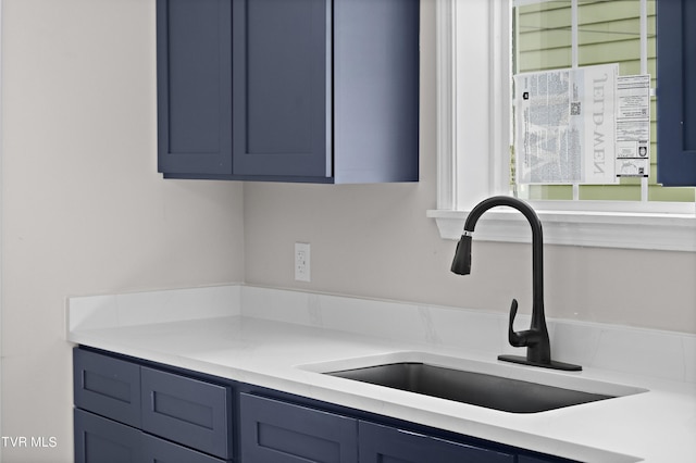 interior space featuring blue cabinetry and sink