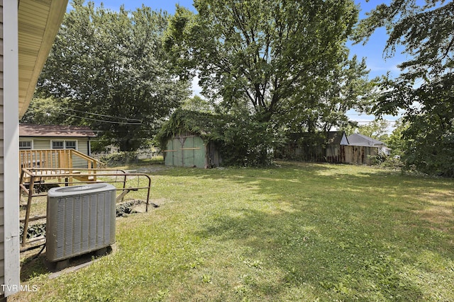 view of yard featuring a storage unit and central AC unit