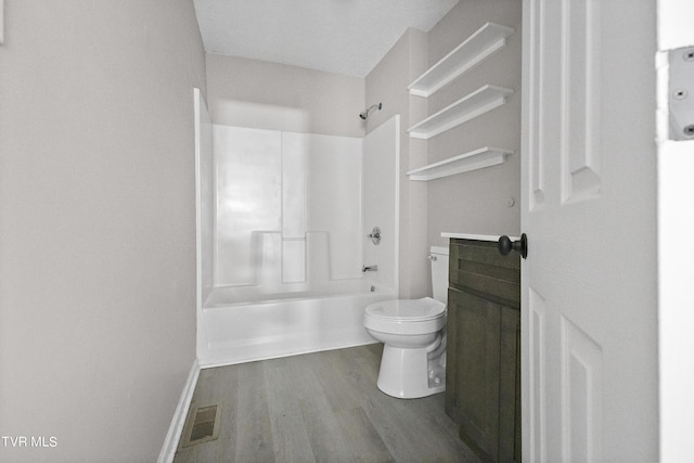 full bathroom with hardwood / wood-style flooring, toilet, vanity, and shower / bathing tub combination