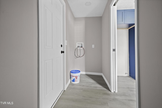 hallway with light hardwood / wood-style floors