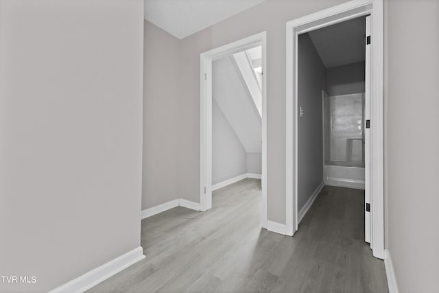 corridor with light hardwood / wood-style floors