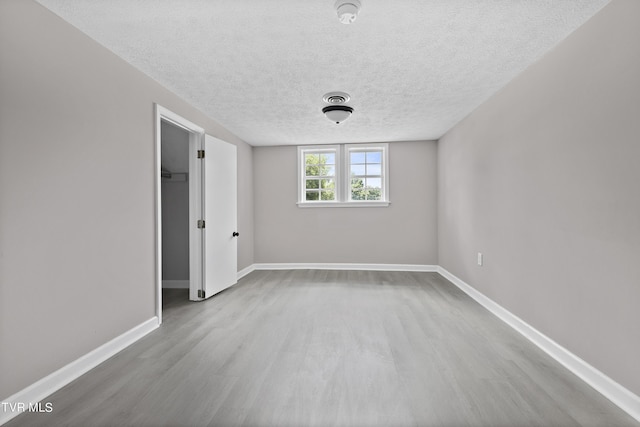 unfurnished bedroom featuring a textured ceiling and light wood-type flooring