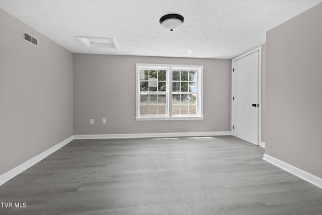 empty room featuring hardwood / wood-style floors and a textured ceiling