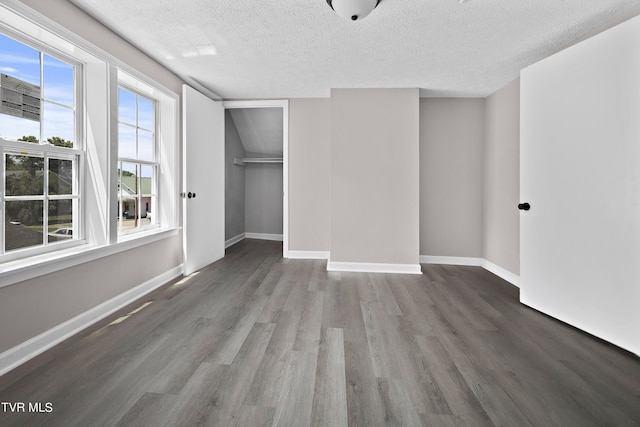 unfurnished bedroom featuring hardwood / wood-style flooring, a closet, and a textured ceiling