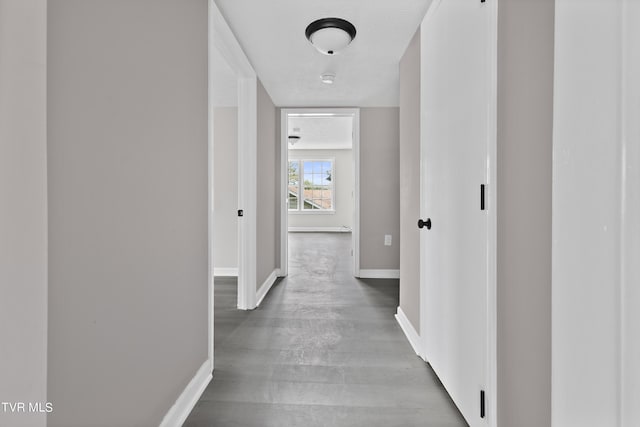 corridor with hardwood / wood-style flooring