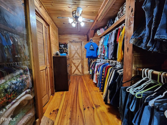 spacious closet with ceiling fan and light wood-type flooring