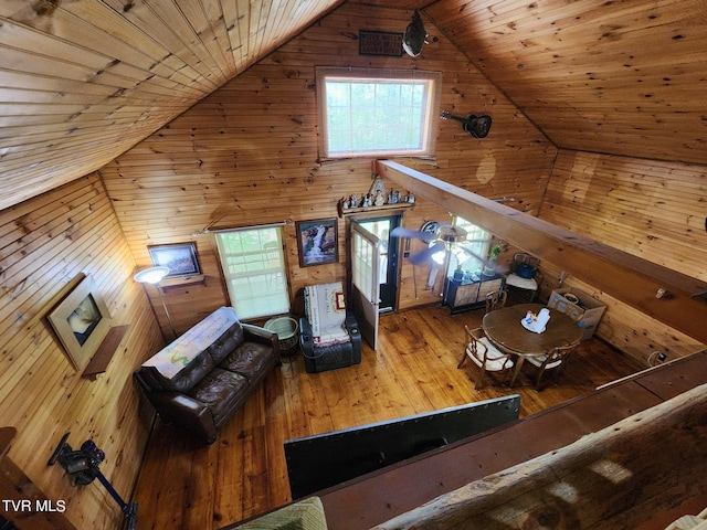 living room with wooden ceiling, hardwood / wood-style flooring, lofted ceiling, and wooden walls