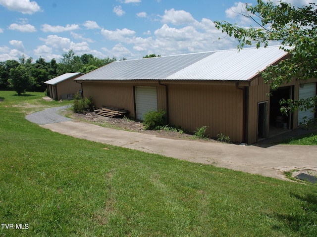 view of home's exterior featuring a garage and a lawn