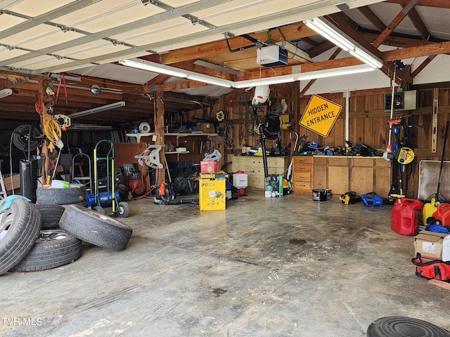 garage with a workshop area and a garage door opener