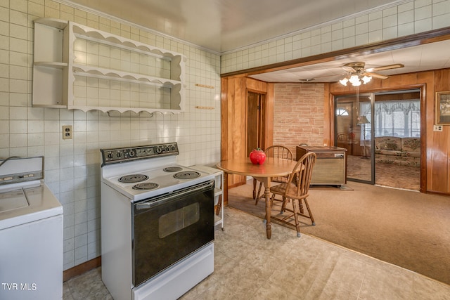 kitchen with ceiling fan, white electric range, washer / dryer, and tile walls