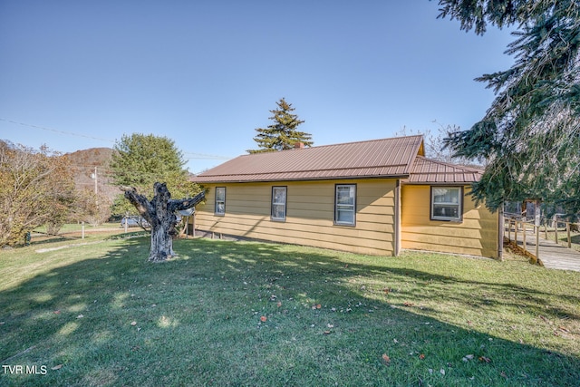 back of house with a lawn