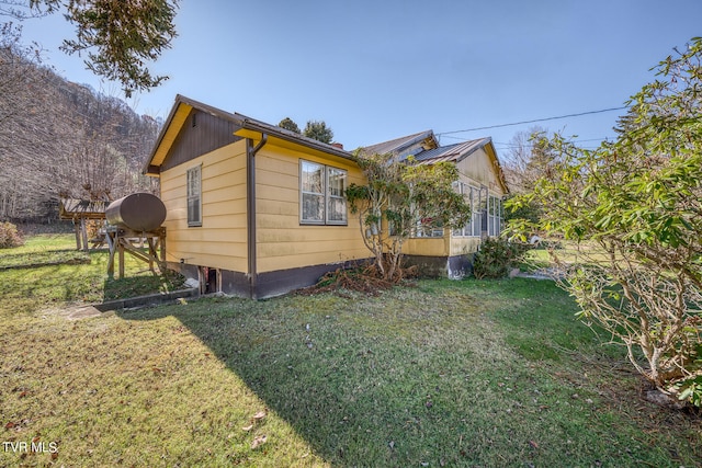 view of home's exterior with a yard