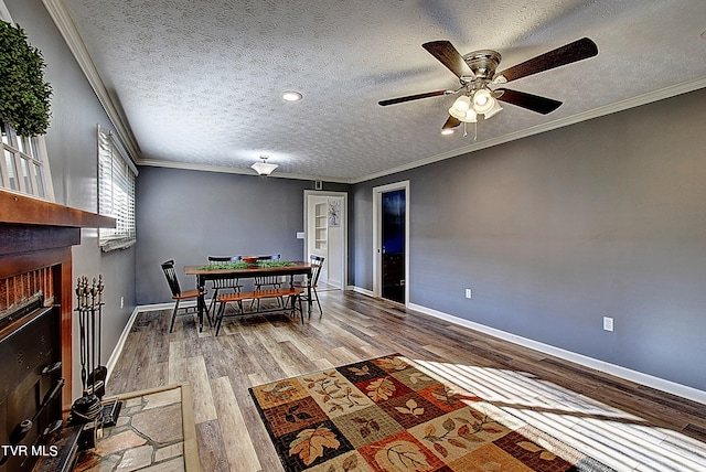 interior space with a textured ceiling, a brick fireplace, and hardwood / wood-style floors