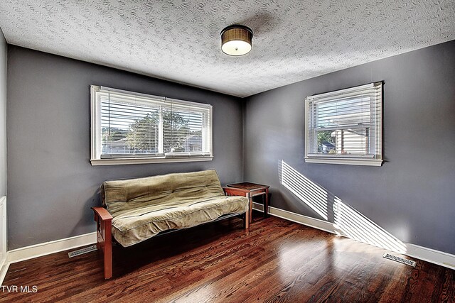 sitting room with a textured ceiling and hardwood / wood-style flooring