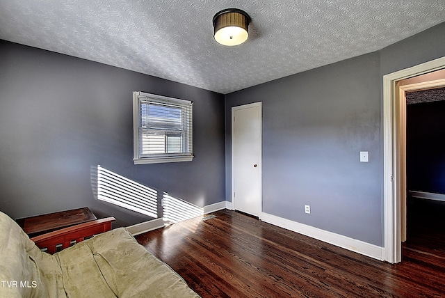 interior space featuring wood-type flooring and a textured ceiling