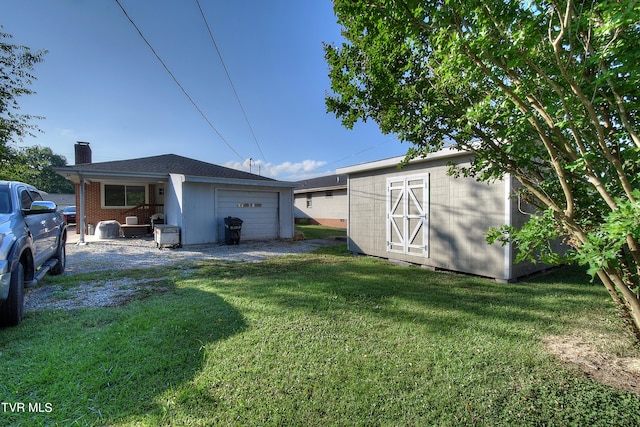 view of yard featuring a garage and a storage unit