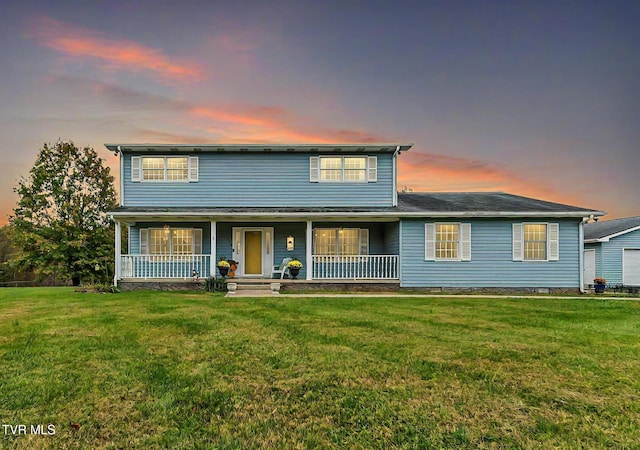 front of property featuring a lawn and covered porch